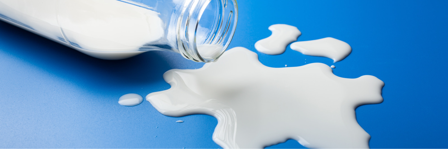 An image of a bottle of milk tipped over.